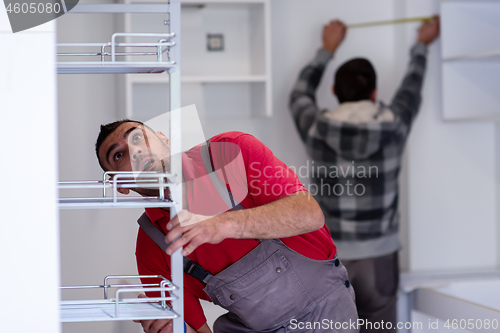 Image of workers installing a new kitchen