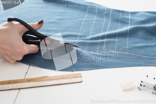 Image of Designer Cutting Fabric