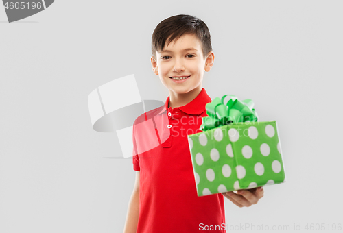 Image of smiling boy in red t-shirt with birthday gift box