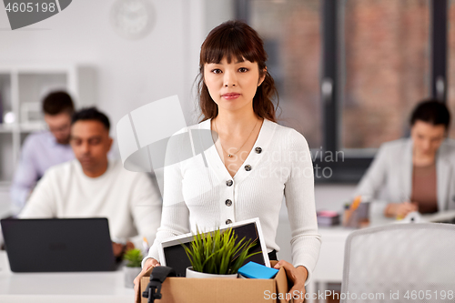 Image of female office worker with box of personal stuff