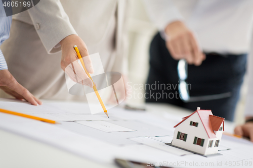 Image of close up of architects with blueprint at office