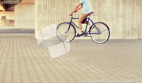 Image of hipster man riding fixed gear bike