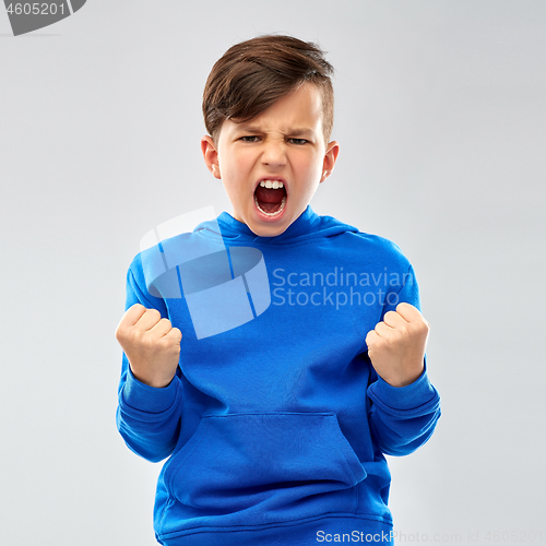 Image of angry boy in blue hoodie celebrating success