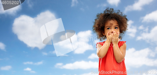 Image of confused african american gir over blue sky