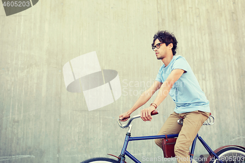 Image of young hipster man riding fixed gear bike