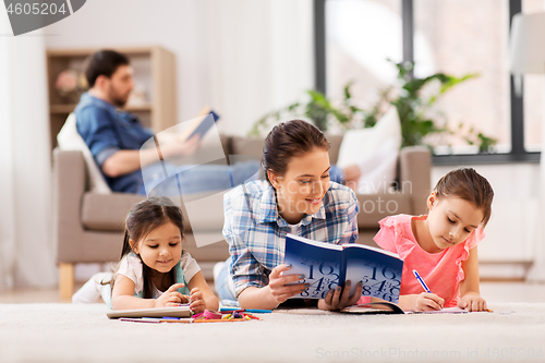 Image of mother with little daughters drawing at home