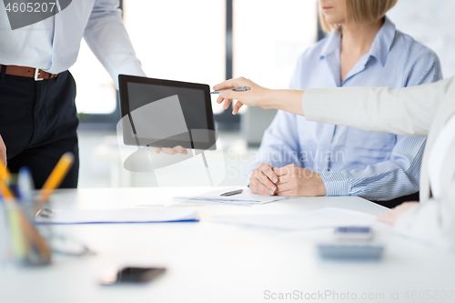 Image of close up of business team with tablet pc at office