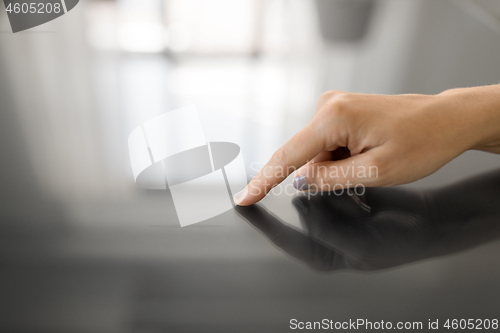 Image of hand using black interactive panel