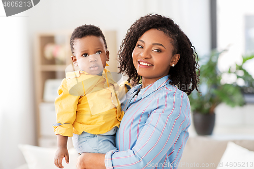 Image of happy african american mother with baby at home