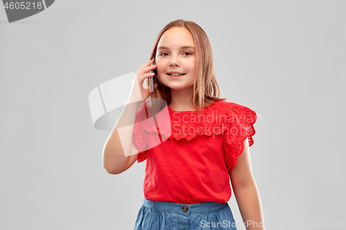 Image of beautiful smiling girl calling on smartphone