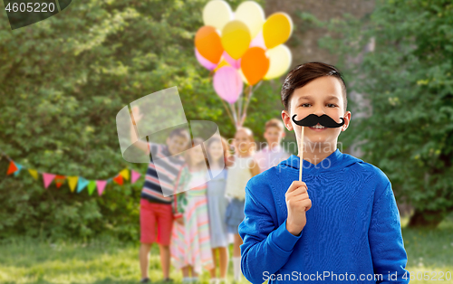 Image of happy boy with black moustaches at birthday party