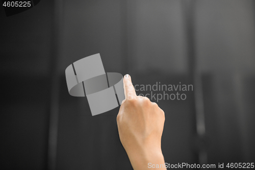 Image of hand using black interactive panel