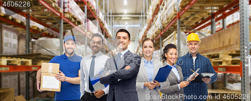 Image of group of business people and warehouse workers