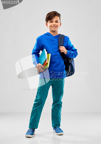 Image of smiling student boy with books and school bag