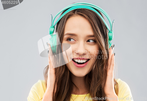 Image of happy young woman or teenage girl with headphones