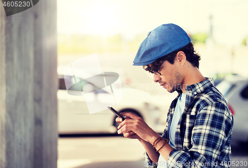 Image of hipster man texting message on smartphone