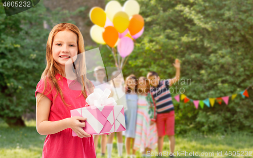 Image of red haired girl with gift at birthday party