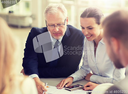 Image of architects with smartphone and blueprint at office