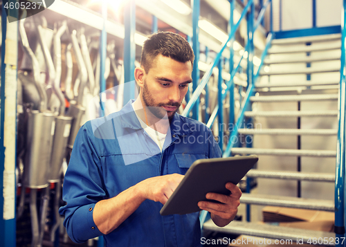 Image of auto mechanic or smith with tablet pc at workshop