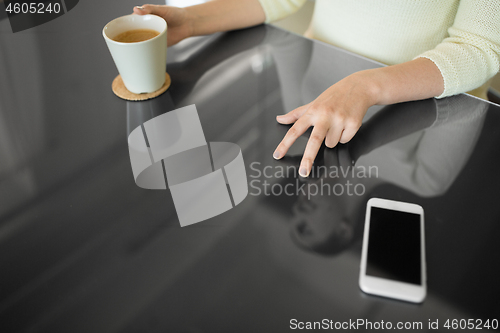 Image of woman with coffee using black interactive panel