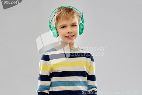 Image of smiling boy in headphones listening to music