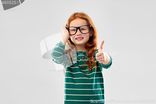 Image of smiling red haired student girl in glasses