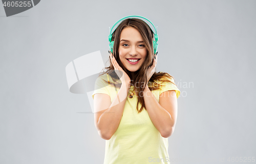 Image of happy young woman or teenage girl with headphones