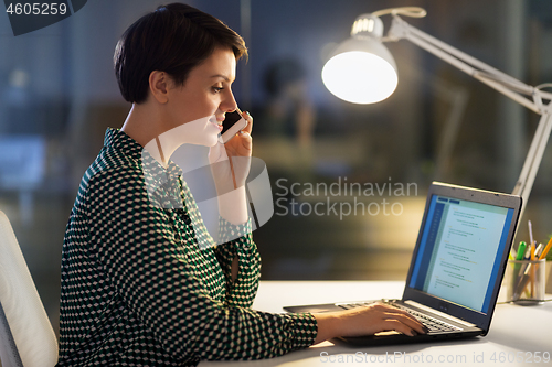 Image of businesswoman calling on smartphone at office