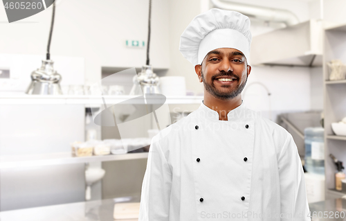 Image of happy male indian chef at restaurant kitchen