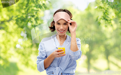 Image of woman in pajama and sleeping mask with juice