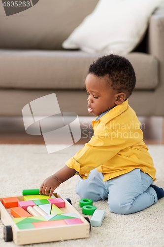 Image of african american baby boy playing with toy blocks