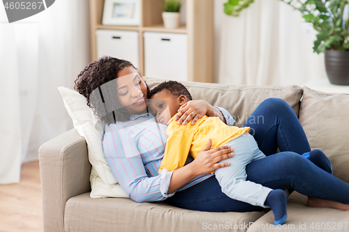 Image of happy african american mother with baby at home