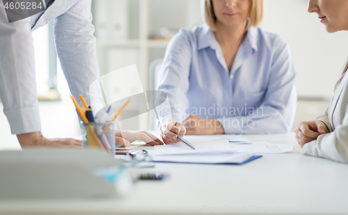 Image of business team discussing papers at office