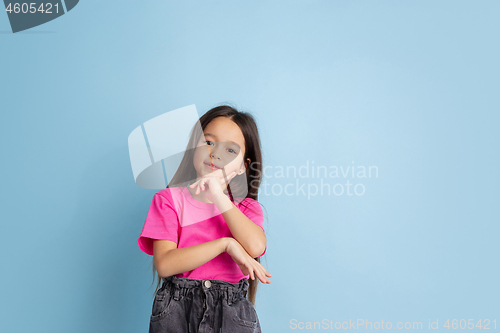 Image of Caucasian little girl\'s portrait on blue studio background