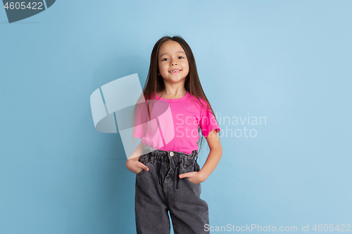 Image of Caucasian little girl\'s portrait on blue studio background