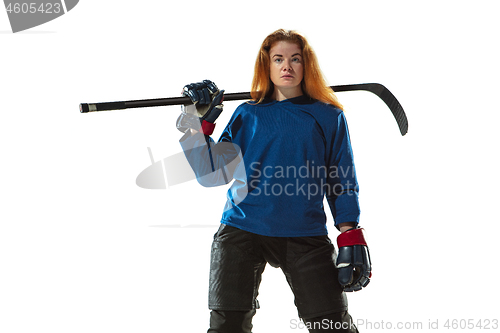 Image of Young female hockey player with the stick on ice court and white background