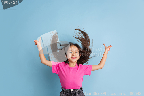 Image of Caucasian little girl\'s portrait on blue studio background