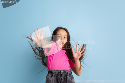 Image of Caucasian little girl\'s portrait on blue studio background