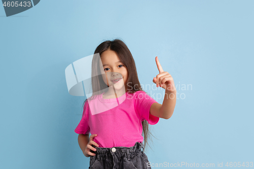 Image of Caucasian little girl\'s portrait on blue studio background