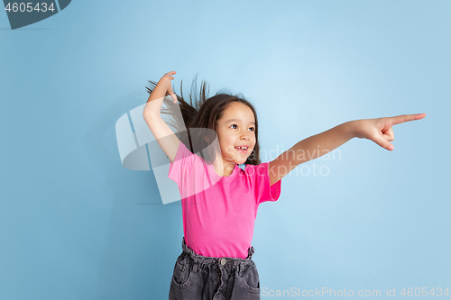 Image of Caucasian little girl\'s portrait on blue studio background