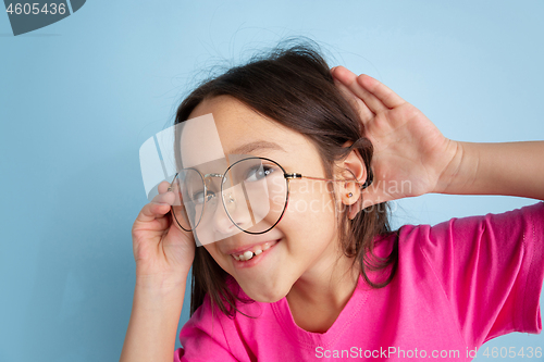 Image of Caucasian little girl\'s portrait on blue studio background