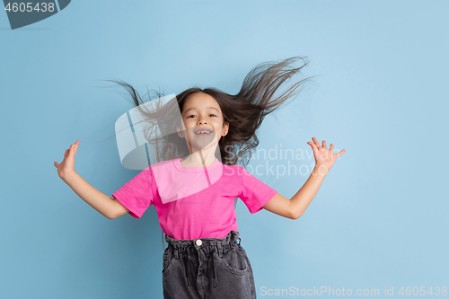 Image of Caucasian little girl\'s portrait on blue studio background