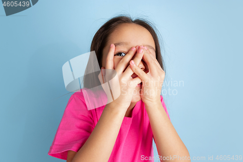 Image of Caucasian little girl\'s portrait on blue studio background