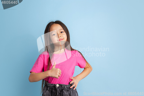 Image of Caucasian little girl\'s portrait on blue studio background