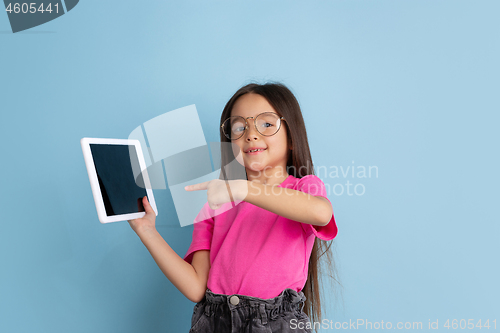 Image of Caucasian little girl\'s portrait on blue studio background