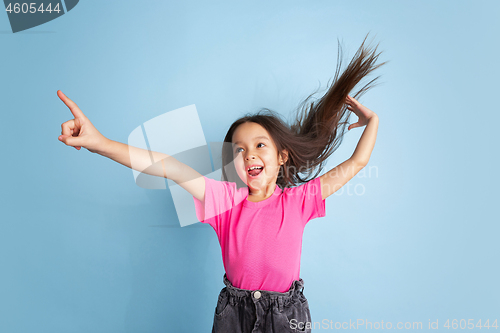 Image of Caucasian little girl\'s portrait on blue studio background