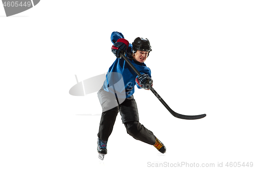 Image of Young female hockey player with the stick on ice court and white background