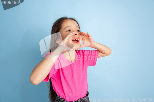 Image of Caucasian little girl\'s portrait on blue studio background