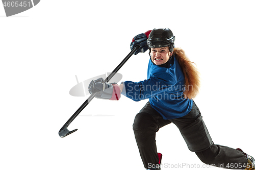 Image of Young female hockey player with the stick on ice court and white background