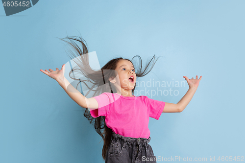 Image of Caucasian little girl\'s portrait on blue studio background